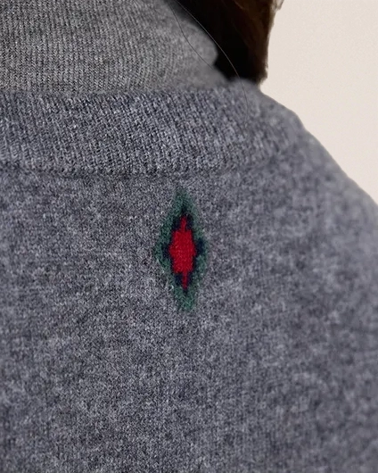 Detail of VIONIS·XY wool cardigan embroidery, vintage floral accent on soft fine wool knit