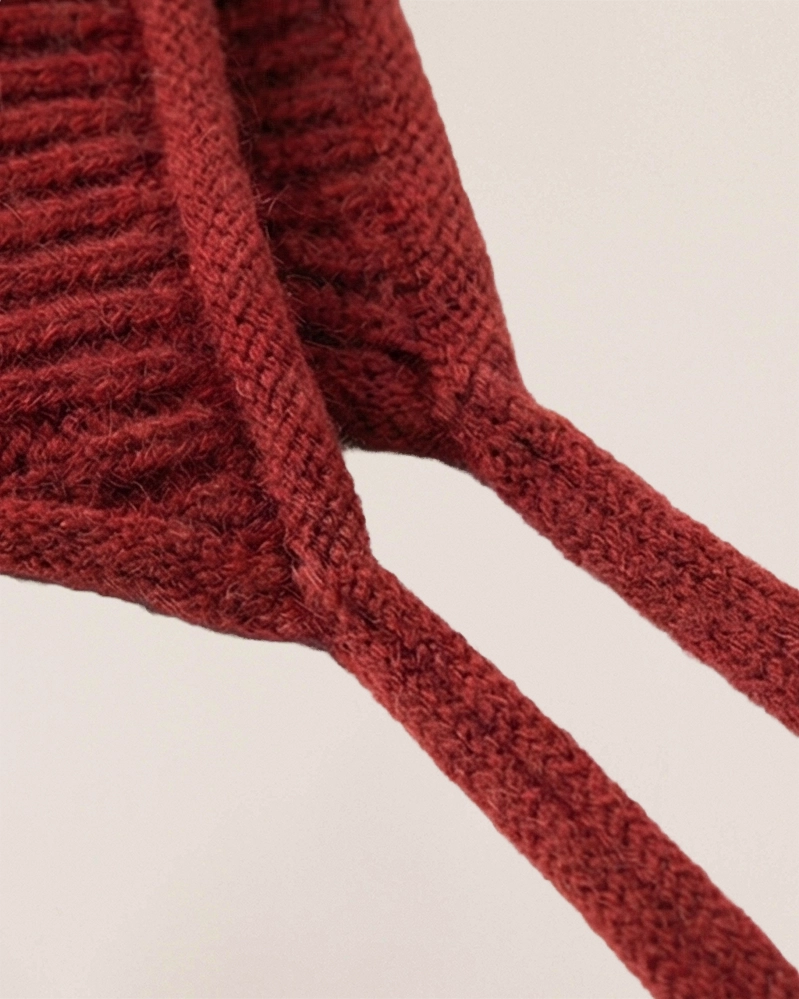 VIONIS·XY scarlet merino tie-bonnet back view, elongated ties for adjustable fit and windproof warmth