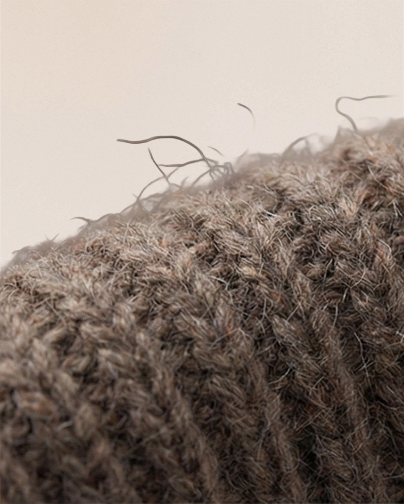 Macro view of VIONIS·XY cocoa merino wool knit, 16S yarn with plush yet airy texture