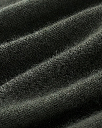 Close-up of folded VIONIS XY forest night cashmere fabric highlighting thickness and warmth