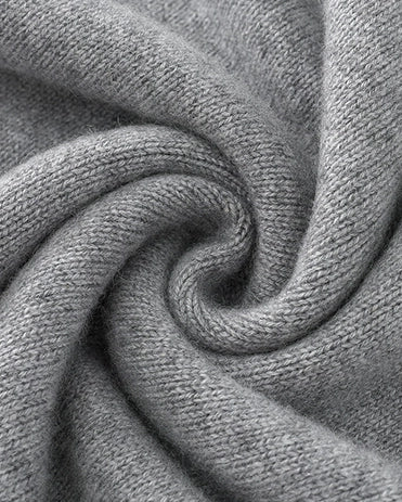 Close-up of folded VIONIS XY heather grey cashmere fabric highlighting thickness and softness
